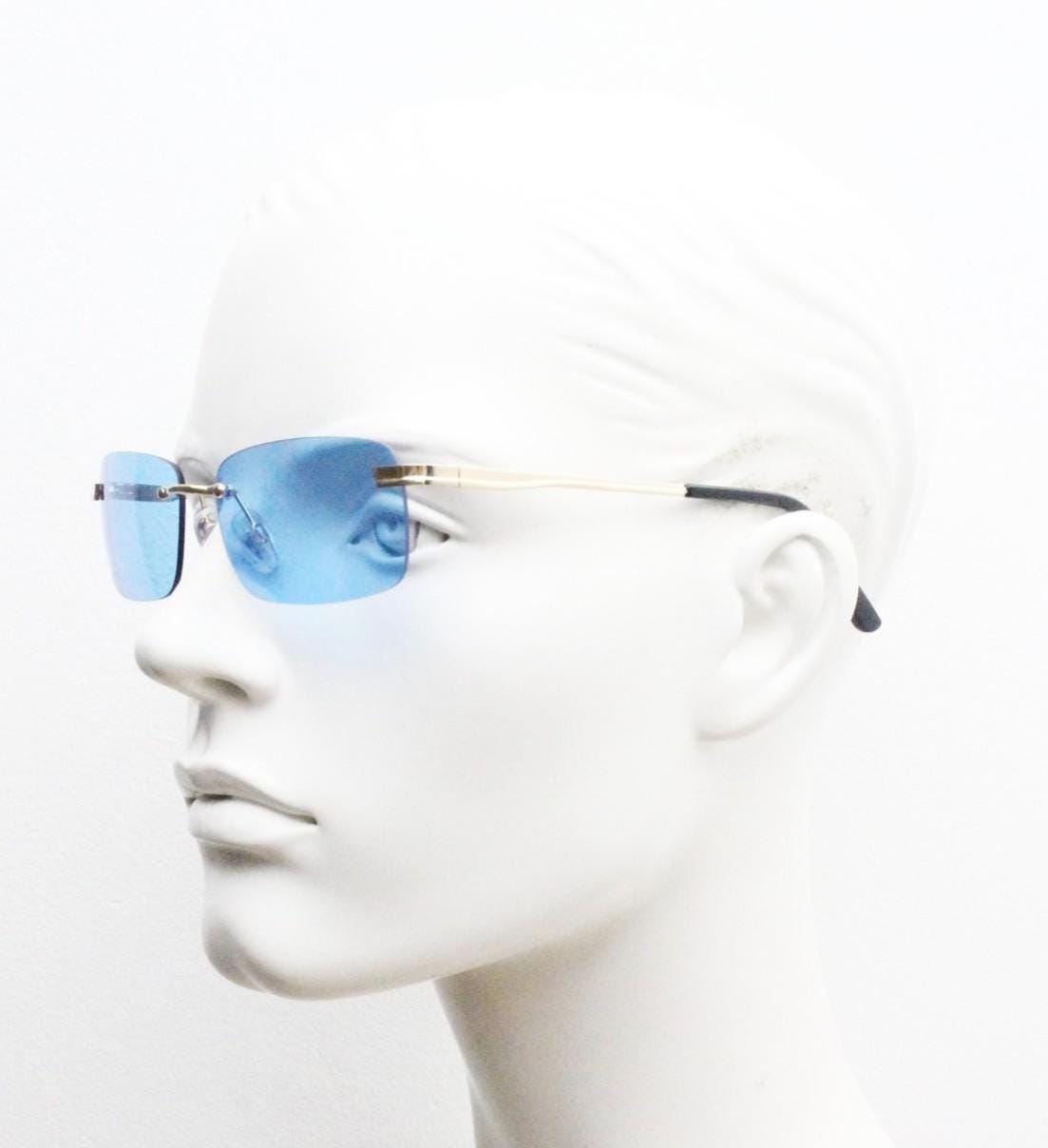 Y2K vintage frameless sky blue sunglasses. Minimalistic rectangular lenses with gold bridge and arms. 2000s club kids. 00's. 90s Rave