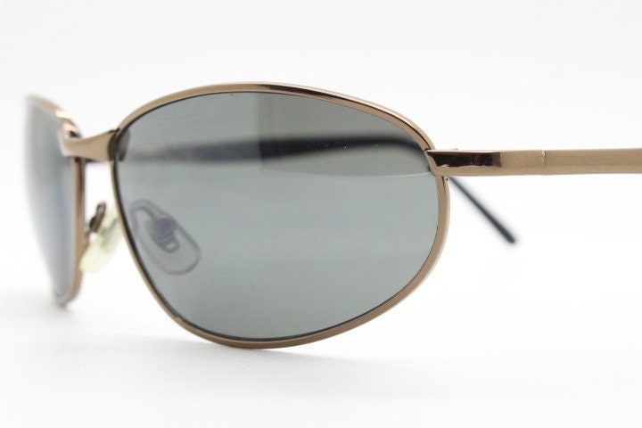 Y2K vintage small bug eye sunglasses. Curved brown chrome metal frame with black arms. Unused 2000s NOS