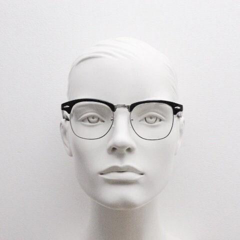 90s vintage black half frame eye glasses. Black gloss browline with silver wire rim frame and clear lenses. Classic 50s, 60s design. NOS