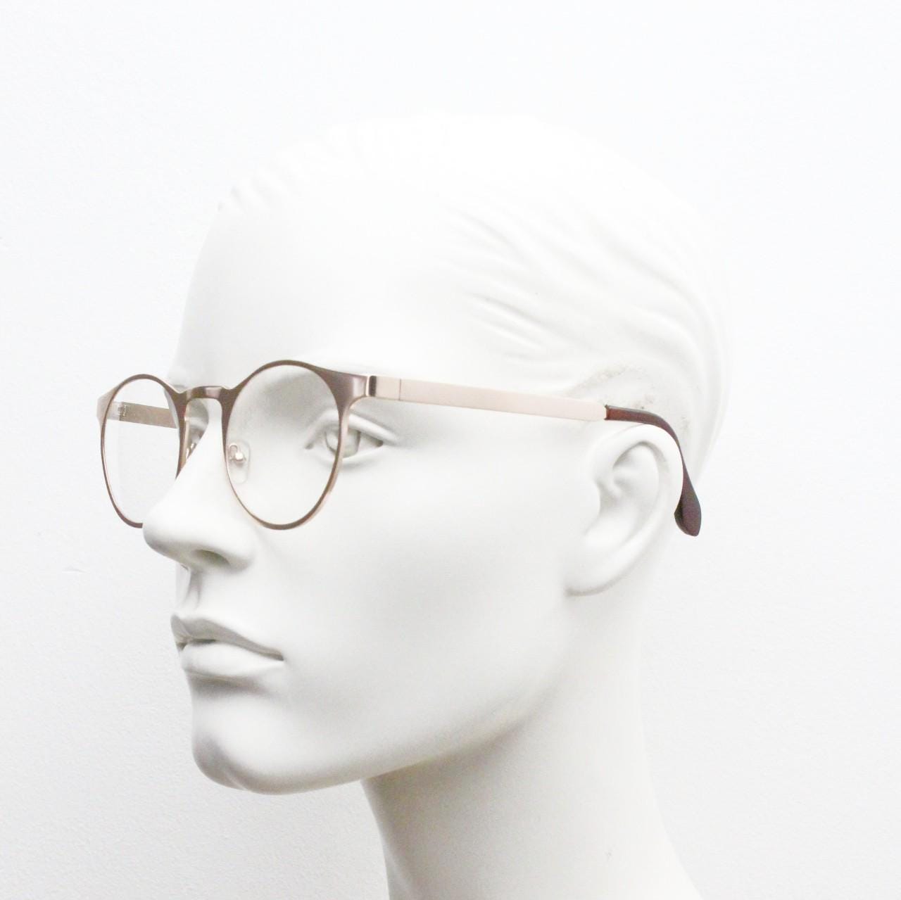 Y2K round metal eye glasses with pointed corners. Solid flat shiny golden frame with clear lenses.