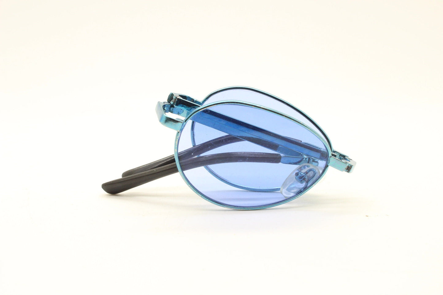 Y2K micro foldable oval sunglasses. Sky lenses in a small folding matching coloured compact frame. Folder. Rave 2000s. 90s NOS