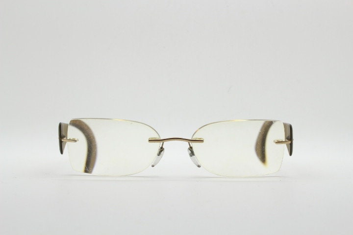 Silhouette rectangular frameless eye glasses model 7599 made in Austria. Minimal optical frame with transparent brown arms. Prescription RX