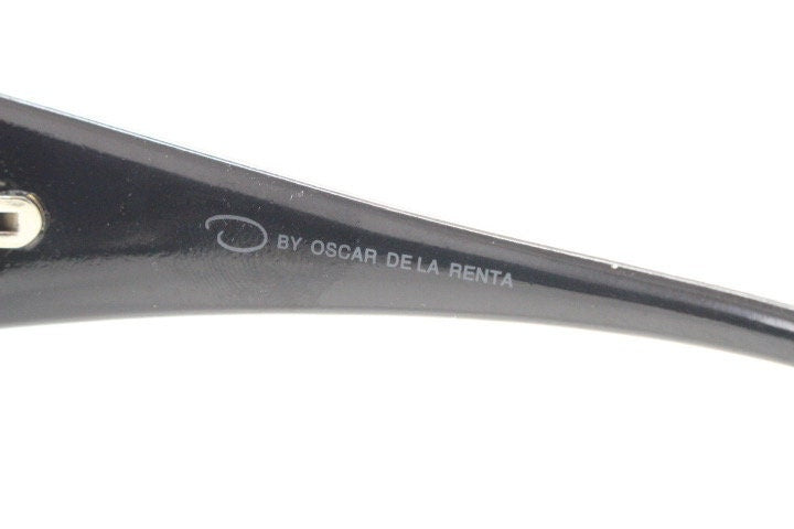 Oscar De La Renta Y2K vintage shield sunglasses. All black gloss wrap around visor with graduating lenses. 2000's bug eye mini mask