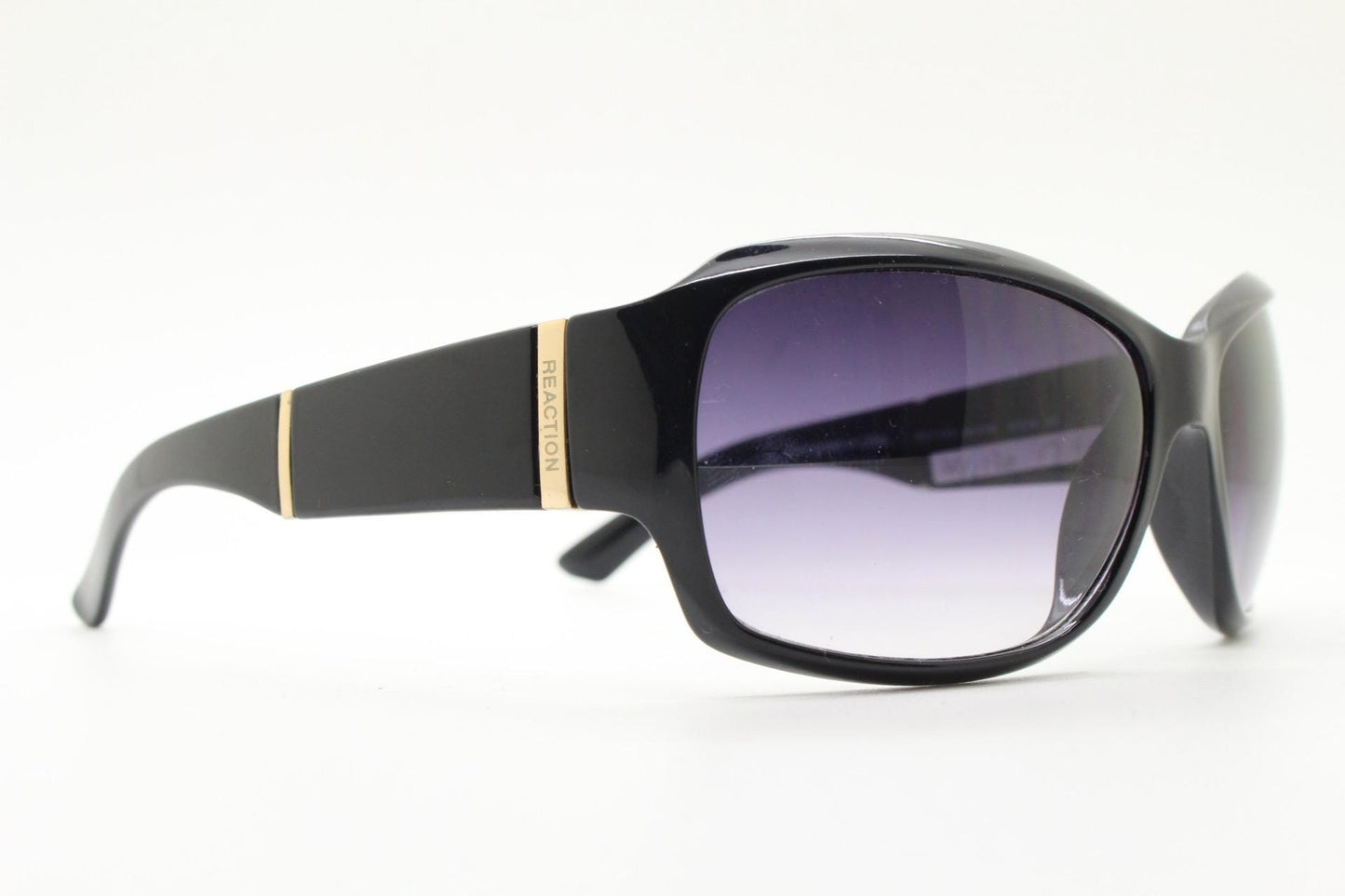 Y2k vintage wrap around sunglasses by Kenneth Cole Reaction. Curved black shield frame with gold trim. 60s bug eye design. 2000's NOS