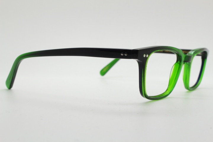 Green rectangular low profile wayfarer design eye glasses by found of Switzerland. Green gloss acetate optical frames. Prescription RX