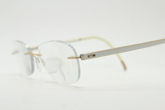 Silhouette rectangular frameless eye glasses made in Austria. Minimal lightweight gold with white enamel frame. 90s vintage. Prescription RX