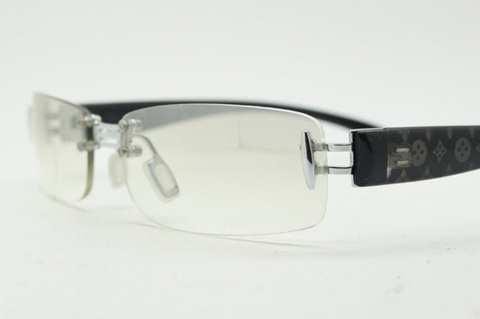 Y2K vintage frameless sunglasses. Silver chrome trim with patterned arms and extra light tone graduated curved mirror lenses. 2000's. 90s
