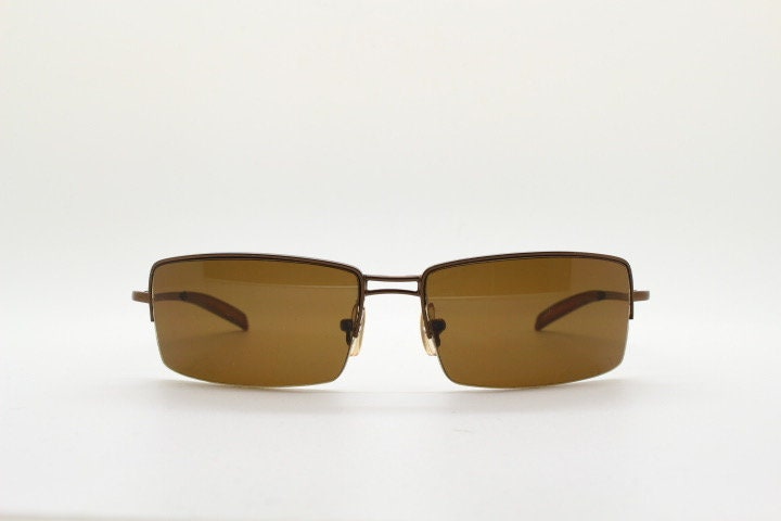 Y2K vintage curved rectangular sunglasses. Minimal half frame in brown chrome with mid tone lenses and straight arms. 2000's. 00's NOS