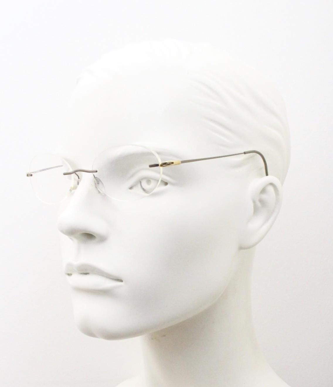 Silhouette vintage oval frameless eye glasses made in Austria. Minimal lightweight satin bronze optical frame. Prescription spectacles