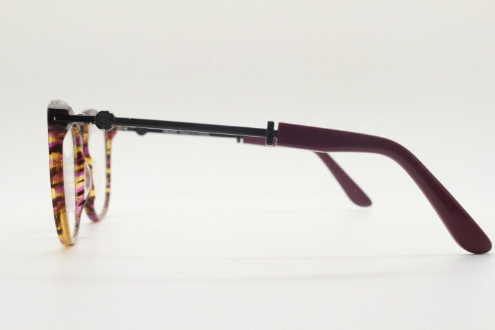 Kenzo vintage round eye glasses made in France. Tortoise with purple tones and matching arm sections. Womens Prescription Optical frames. RX