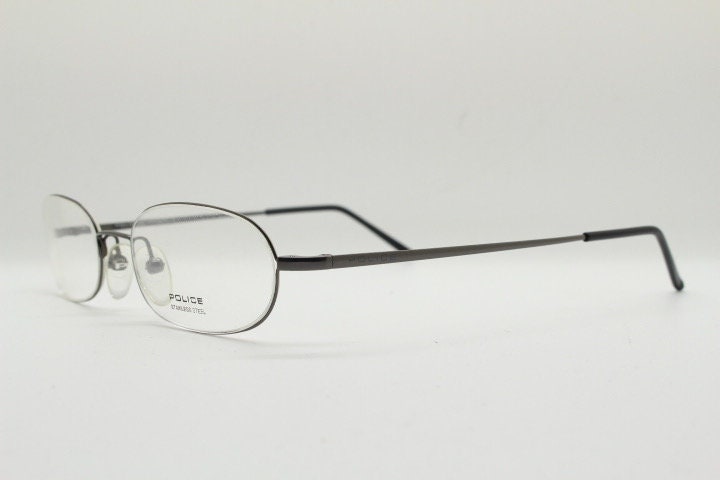 Police 90s vintage oval half rim eye glasses made in Italy. Minimal lightweight optical frame in gunmetal grey. Prescription RX Spectacles