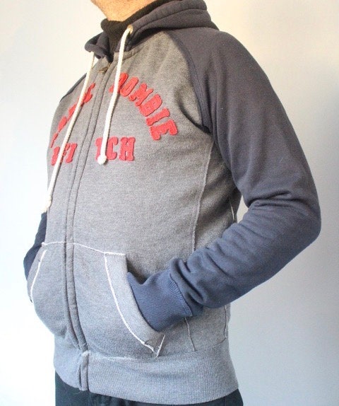 Abercrombie and Fitch grey and blue zipper sweat hoody with large red spell out patch letter chest logo. Mens all cotton medium size