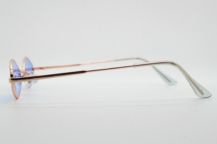 90s vintage small diamond sunglasses. Minimal gold psychedelic mod style frame with sky blue lenses. Unused New Old Stock