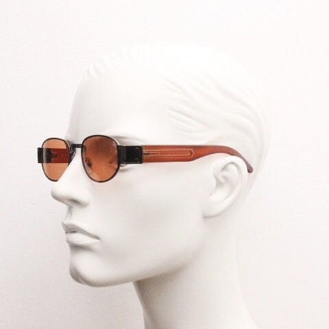 90s vintage low profile sunglasses. Brown chrome frame with thick transparent amber arms and orange lenses. Unused. BNWT