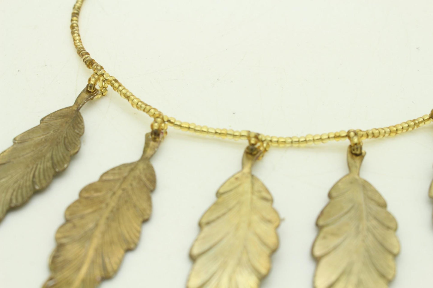 80s vintage gold beaded necklace with large dangling leaves . Charming statement piece. Country and western. Native american