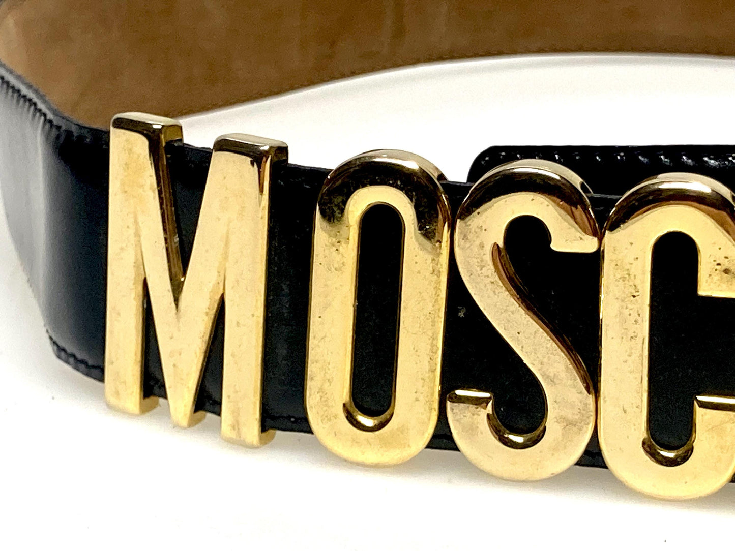 Moschino 90s vintage womens dress belt in black genuine leather. Iconic individual golden moving letters logo. Made in Italy. 80s. NOS