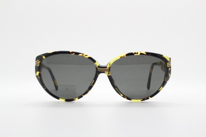 Gucci 90s vintage large oval sunglasses model 2135 made in Italy. Vibrant amber and mottled brown bug eye. NOS