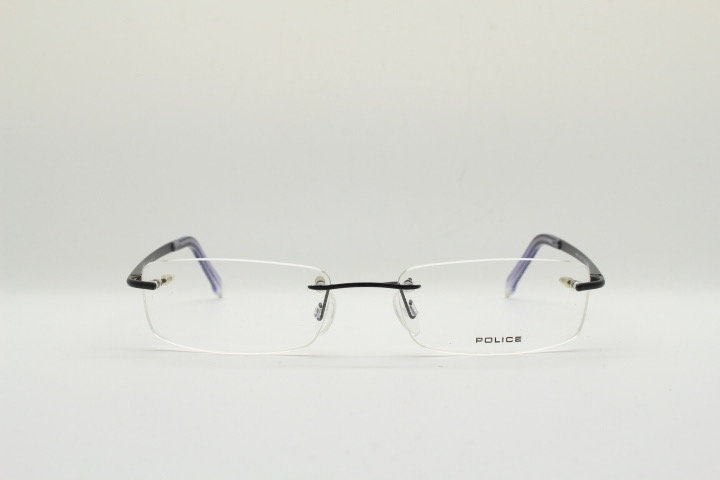 Police 90s vintage rectangular frameless eye glasses made in Italy. Minimal low profile optical frame with black satin metal trim. RX