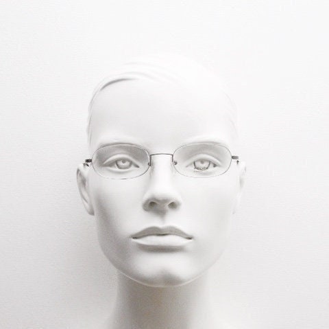 Police 90s vintage oval half rim eye glasses made in Italy. Minimal lightweight optical frame in gunmetal grey. Prescription RX Spectacles