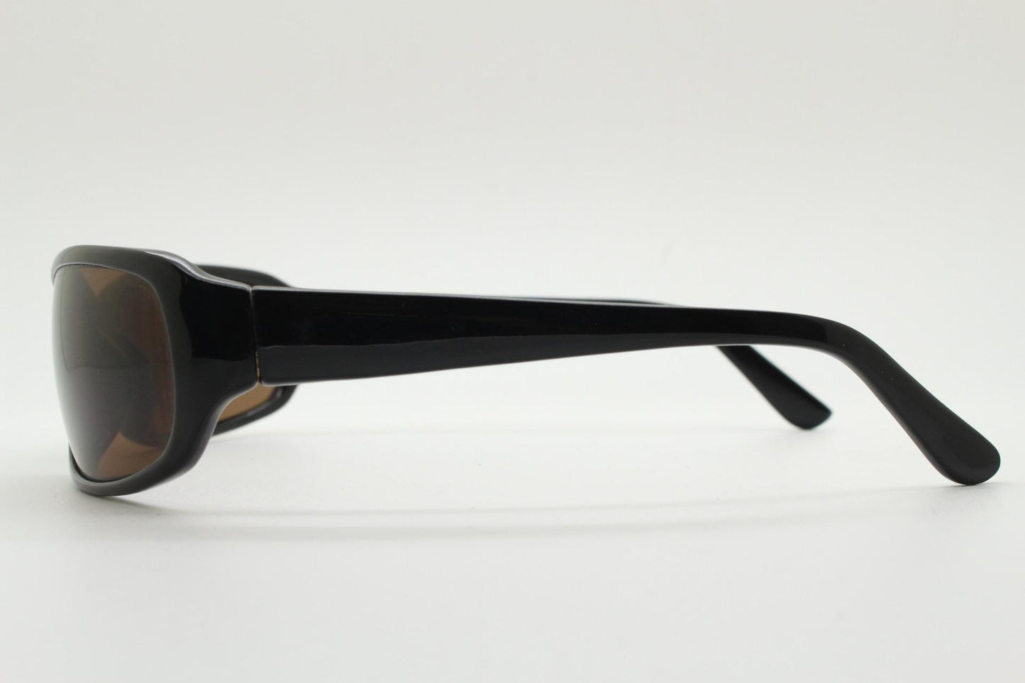 Y2k vintage wrap around rectangular sunglasses. Low profile curved black gloss frame with plain brown lenses. 2000's bug eye. NOS