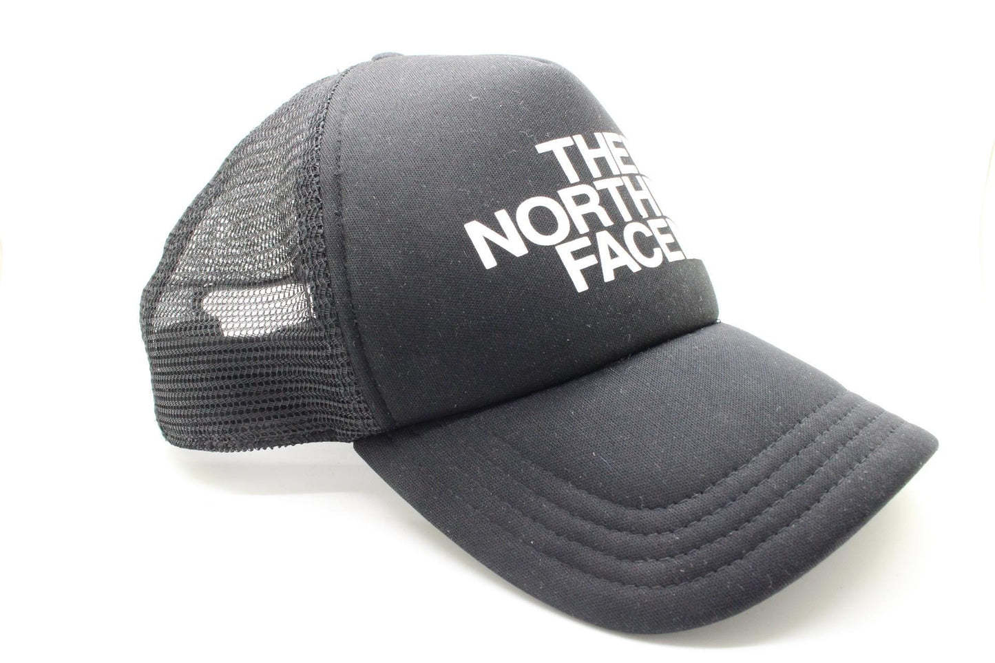 The North Face plain black baseball cap with big white spell out logo. Classic trucker style hat with fully adjustable back