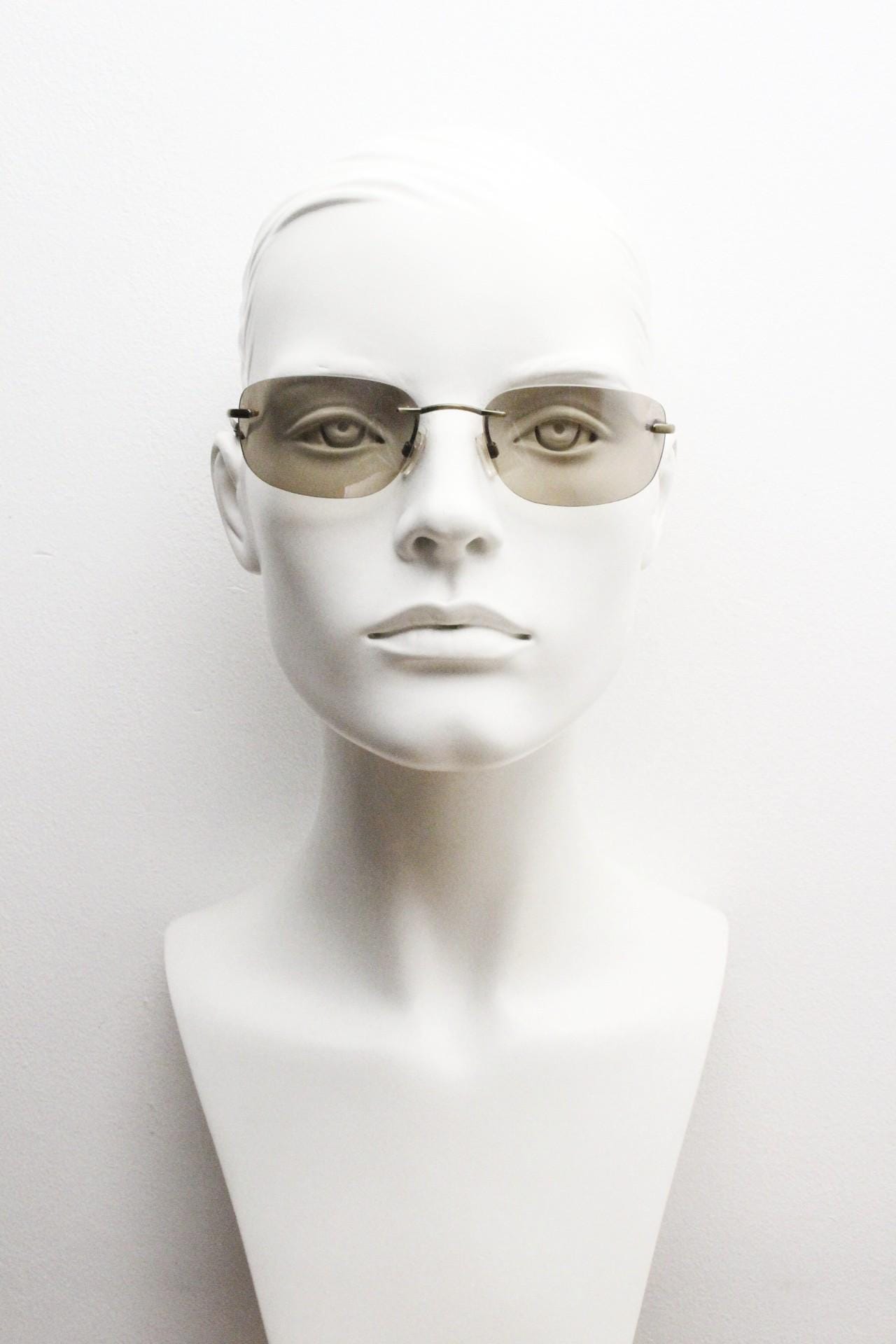 Ben Sherman 90s vintage frameless sunglasses. Minimal brown rectangular lens with brown chrome trim in neat proportions. Mens Mod shades