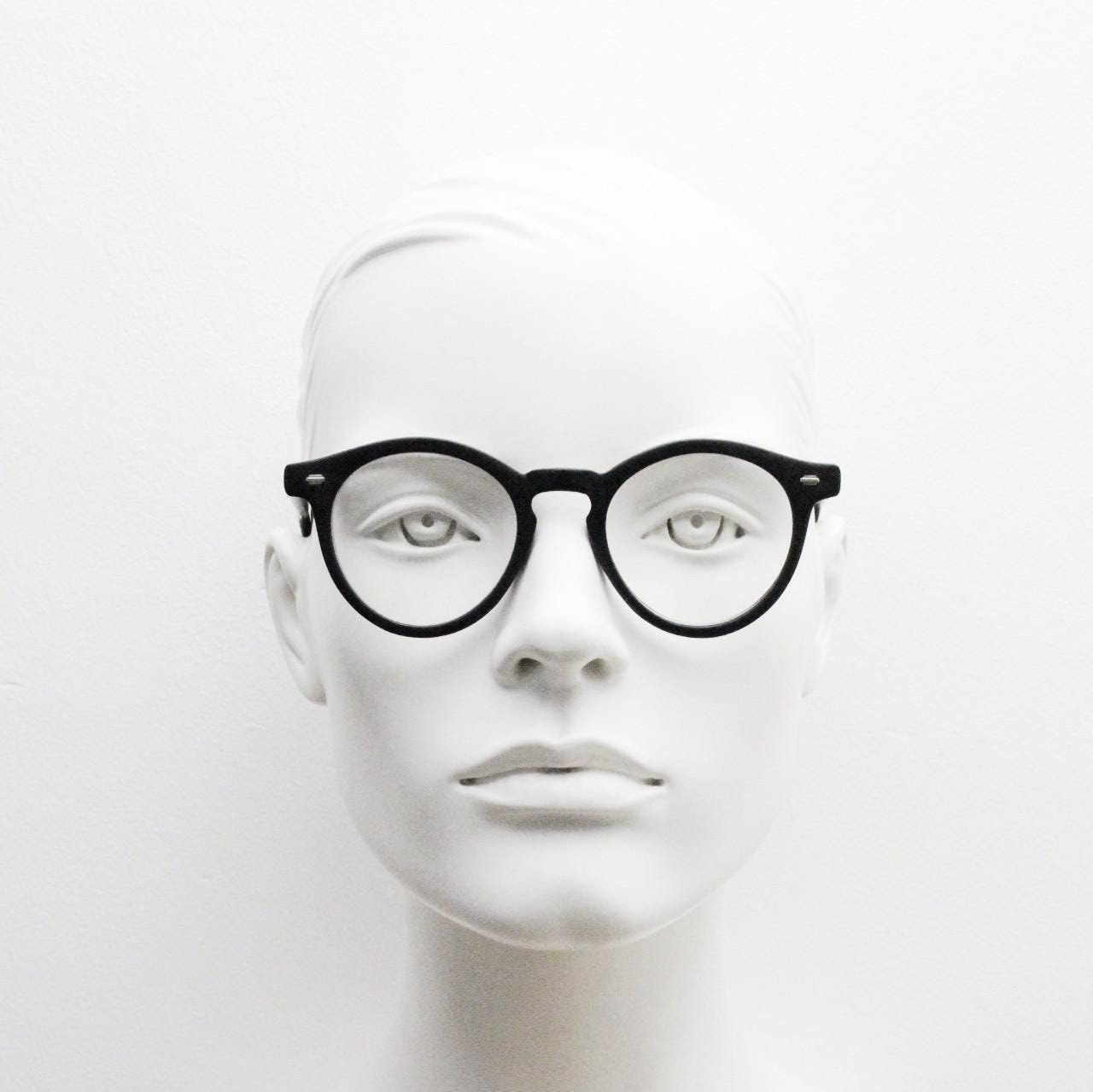 Oliver Smith round eye glasses. Black matt finish optical frames with protruding corners and keyhole bridge. Prescription RX eyeglasses