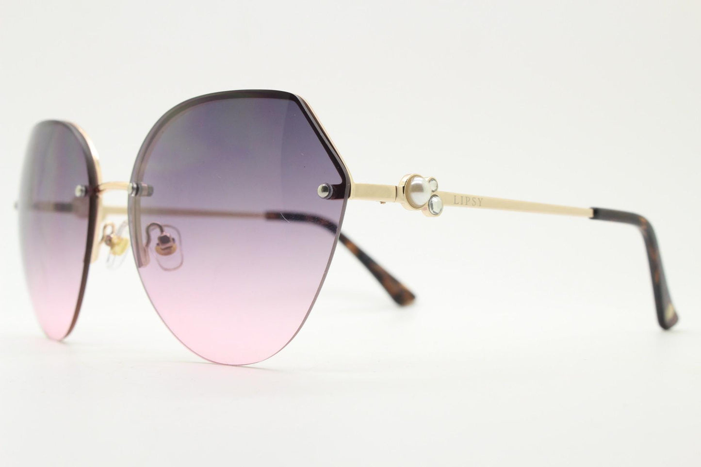 Large rimless sunglasses with dynamic angular grey to pink  graduating lenses. Women's 80s vintage style half frame with gold arms
