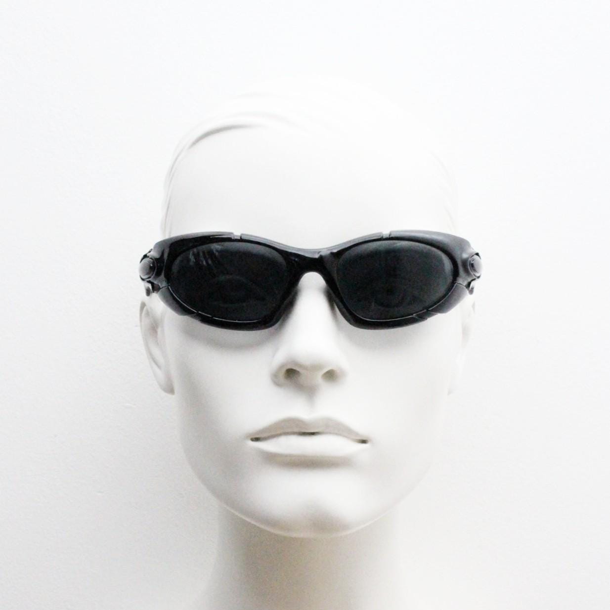 90s vintage sports shield sunglasses. All black gloss aerodynamic wraparound with many stylised features. 2000's. Hells angel uber fashion