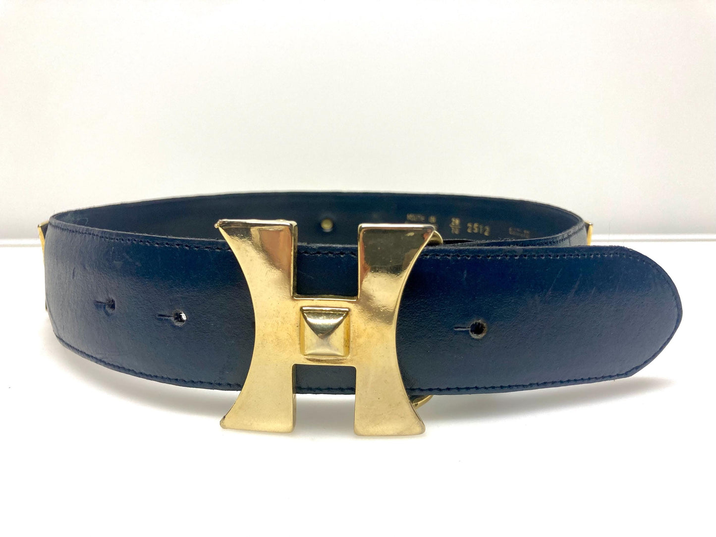 80s vintage womens dress belt in navy blue genuine leather with substantial gold chrome studded 'H' motifs. Made in France. Size S