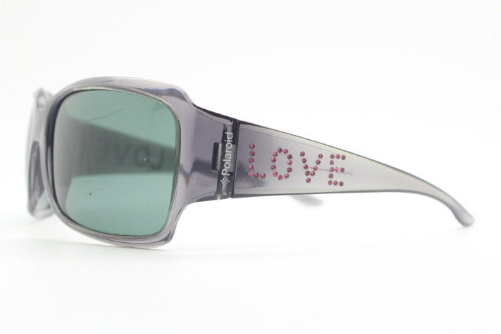 Polaroid Y2K vintage shield sunglasses. Transparent grey wrap around with red diamante LOVE logo and polarising lens. 2000s. Rhinestone