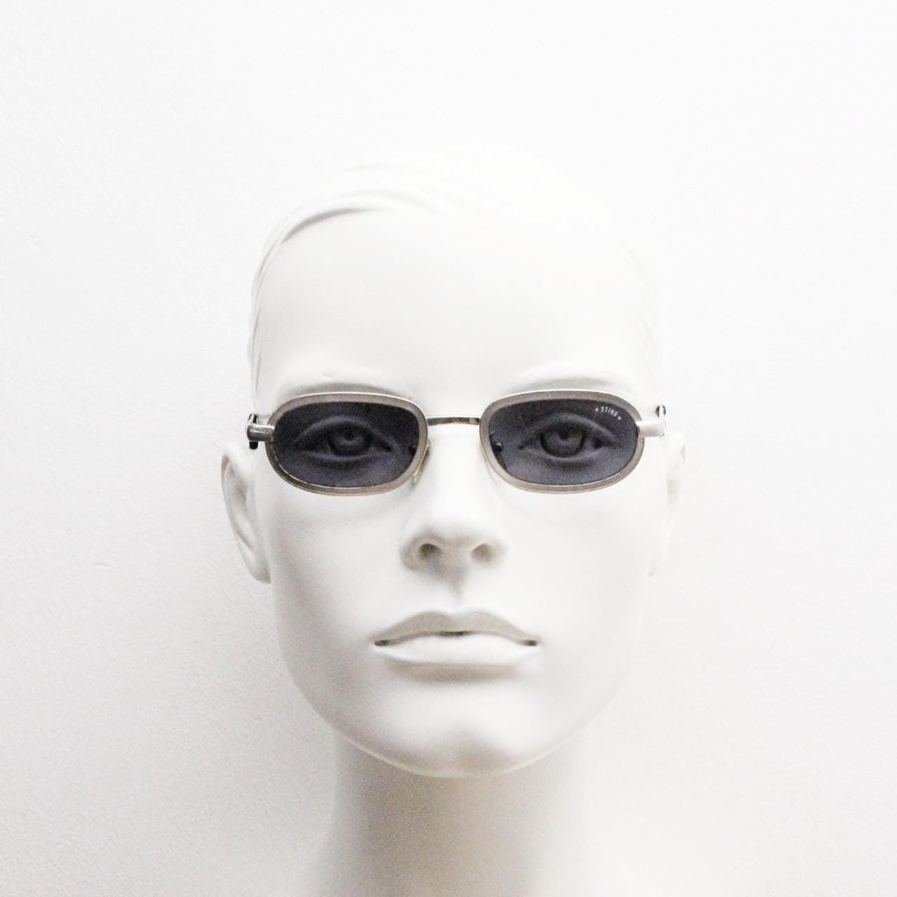 Sting 90s vintage oval sunglasses. Minimal 'Industrial tech' style in slightly small proportions that's quirky but in a quality finish