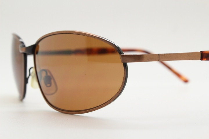 Y2K vintage small bug eye aviator sunglasses. Curved copper brushed finish solid metal frame with tortoise arms. Unused 2000s NOS