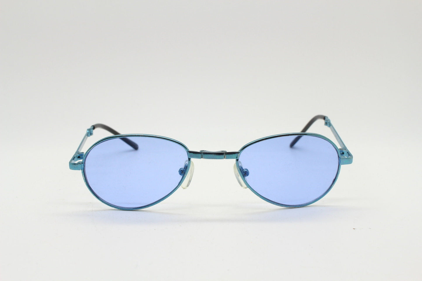 Y2K micro foldable oval sunglasses. Sky lenses in a small folding matching coloured compact frame. Folder. Rave 2000s. 90s NOS