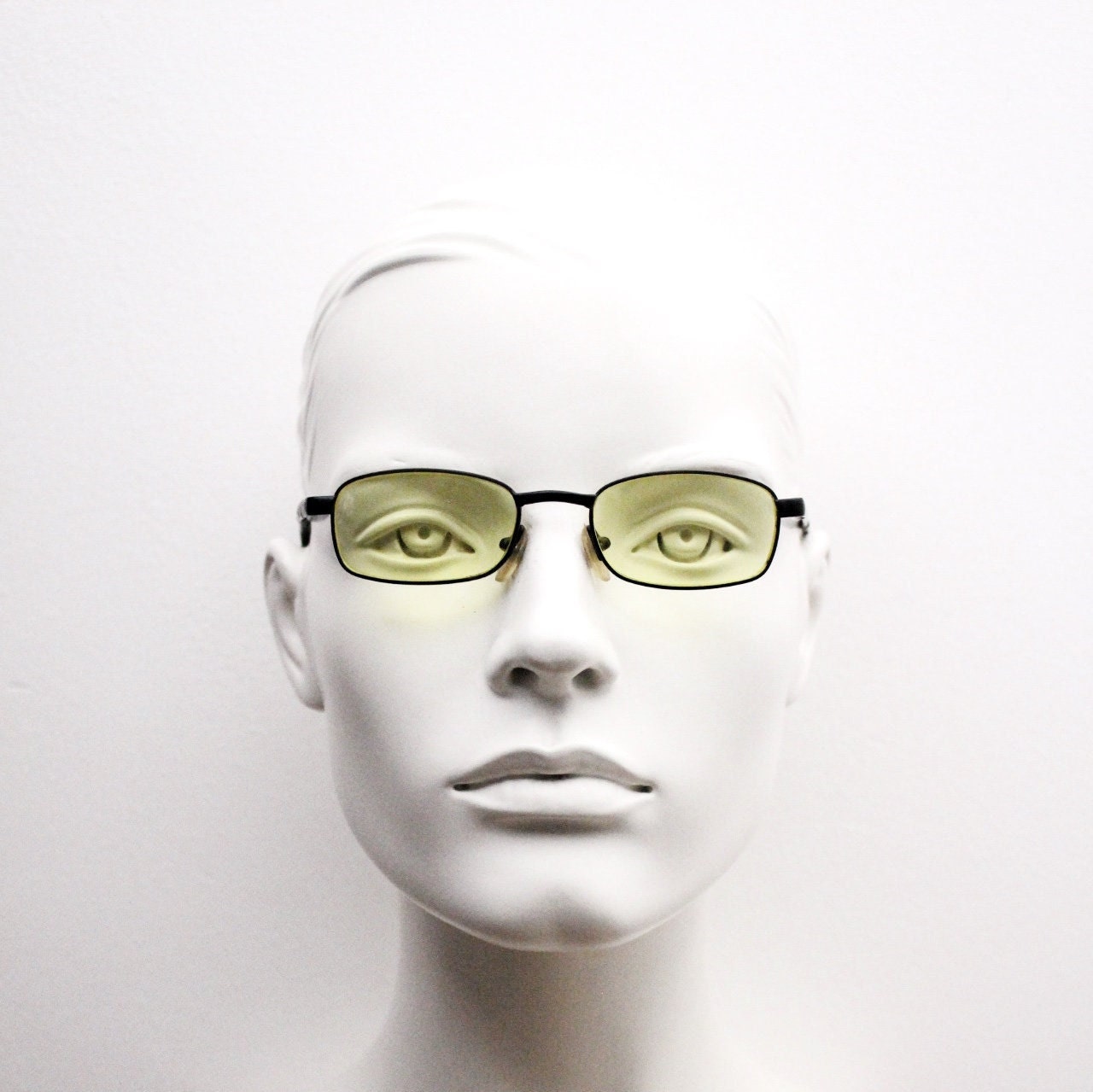 90s vintage small rectangular sunglasses. Minimal plain black matt metal frame with bright yellow lenses. Steampunk. Micro