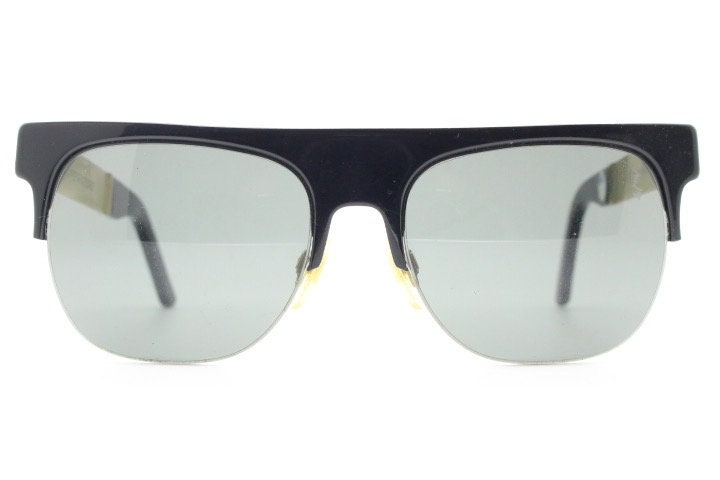 Retrosuperfuture vintage flat top half frame sunglasses hand made in Italy. Black gloss acetate front with tall golden arms