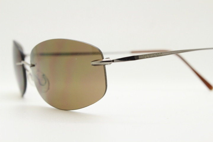 Faconnable 90s vintage sunglasses model 859 hand made in Italy. Minimal frameless design with flexible wire arms and brown chrome trim. NOS