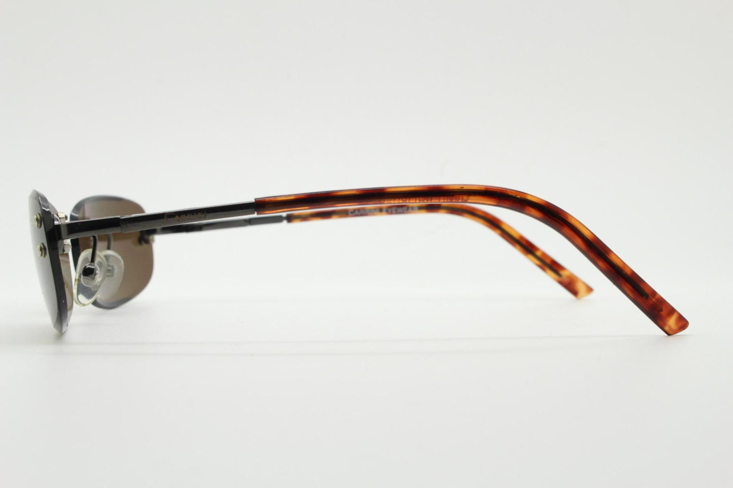 90s vintage minimal frameless sunglasses. Minimal brown rectangular lens with bevelled edges, gunmetal grey trim and tortoise arms. NOS