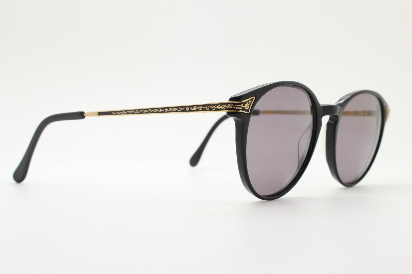 Laura Ashley 90s vintage round sunglasses. Refined 1940s design in black acetate with ornate embossed metal arm details. Unused NOS