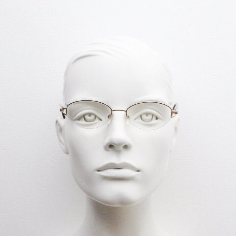 Silhouette oval half frame eye glasses model 6566 made in Austria. Minimal optical frame with gold trim deep purple arms. Prescription RX