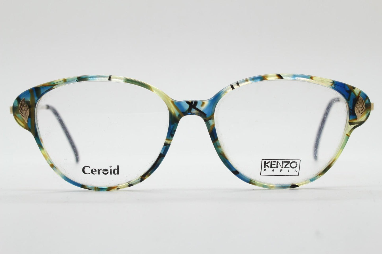 Kenzo 90s vintage cat eye glasses hand made in France. Transparent patterned optical frame with ornate arm details. Womens Prescription. NOS