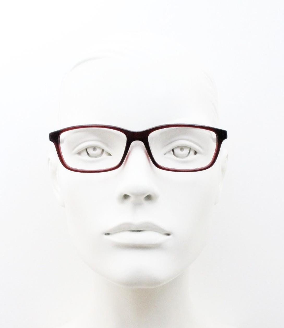 Carolina Herrera rectangular low profile eye glasses. Dark pink acetate optical frames with tasteful arm logo. Prescription RX eyeglasses