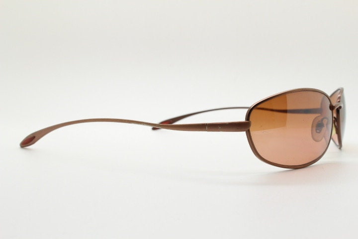 Y2K vintage oval small bug eye sunglasses. Curved copper satin finish metal frame with slender arms. Unused 2000s NOS