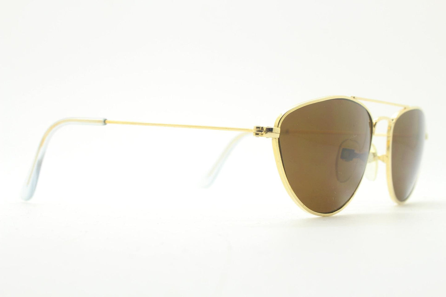 90s vintage minimal triangular sunglasses. Slim gold frame with plain brown lenses. Small modified aviator design. NOS