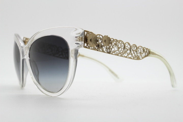Dolce and Gabbana oversized cateye sunglasses model 4211. Womens transparent cat eye with cut-out florid metal arms and smoky lenses. NOS