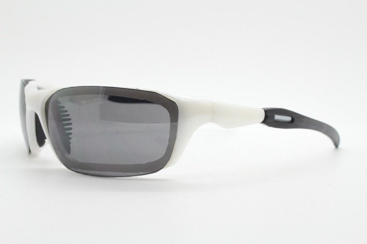 Y2K vintage visor sunglasses. Black and white superhero style sport shield with curved black lenses. Aerodynamic wrap around. NOS rave