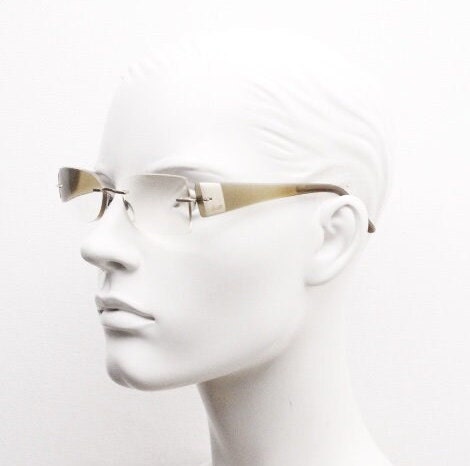 Silhouette rectangular frameless eye glasses model 7599 made in Austria. Minimal optical frame with transparent brown arms. Prescription RX