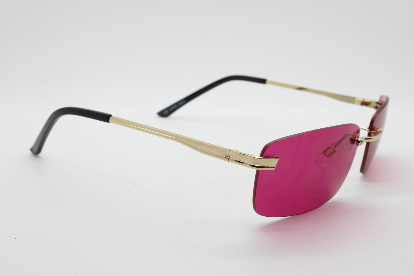 Y2K vintage frameless pink sunglasses. Rectangular lenses with gold bridge and arms. 2000s club kids. 00's. 90s Rave