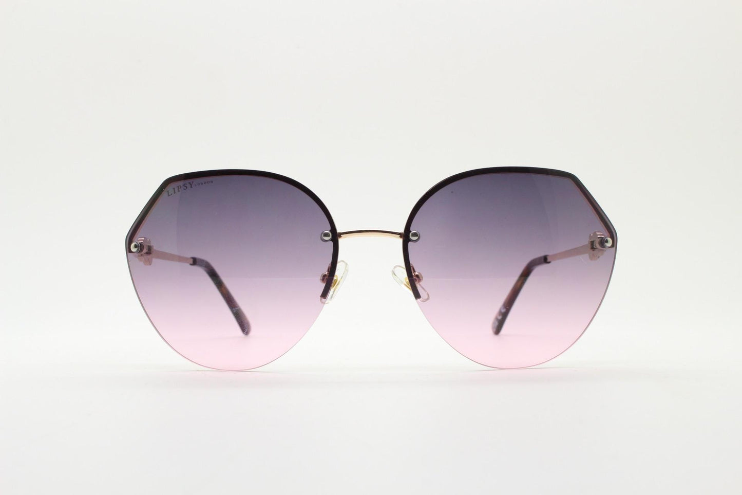 Large rimless sunglasses with dynamic angular grey to pink  graduating lenses. Women's 80s vintage style half frame with gold arms