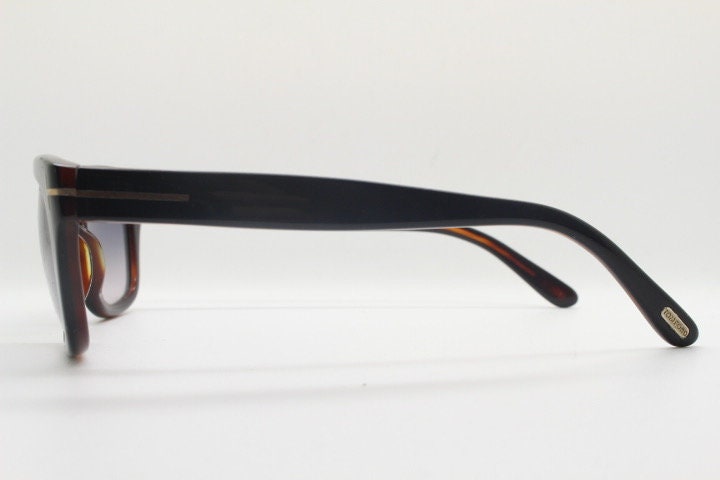 Tom Ford vintage modified wayfarer sunglasses made in Italy. Slightly cat eye form in black gloss acetate with superb graduating lenses